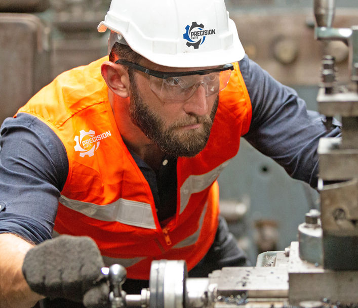 worker setting up lathe